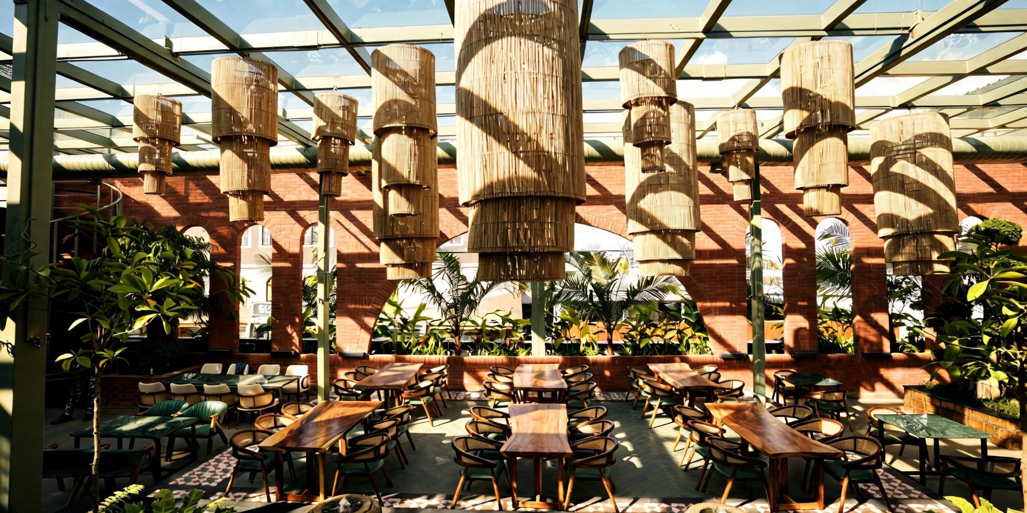 Daylight view of Bier Loft's glasshouse dining hall with tall rattan pendants